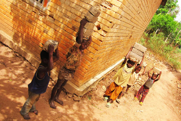 Children carrying bricks, Duru, DR Congo